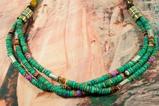 Genuine Assorted Gemstones Necklace. Featuring Genuine Turquoise with Black Onyx, Coral, Sugilite, Melon Shell, Spiny Oyster Shell and Tiger's Eye Accents. Sterling Silver and Gold Fill Barrels with Sterling Silver Beads, Cones and Clasp. Created by Navajo Artist Tommy Singer. Signed.